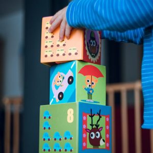 child building an four boxes